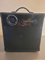 Front view showing grille, tweeter, brand badge