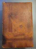 Front cover of leatherbound dictionary showing embossed design