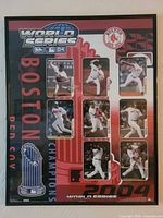Front view of framed 2004 Boston Red Sox World Series poster showing player images and graphics