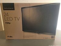 Front of sealed Insignia 24-inch LED TV box showing product image and 720p spec.