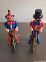 Front view of both wind-up cyclist toys