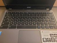 Keyboard and palm rest area showing Acer logo and model sticker