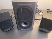 front view of subwoofer and two satellite speakers