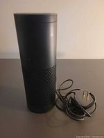 Full view of Amazon Echo speaker with power adapter