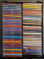 Full rack of roughly 80 CD spines, two columns