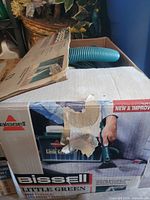 Closed box showing Bissell Little Green branding and open flaps