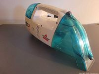 Left side view showing Bissell Spot Lifter body and teal tanks