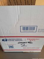 USPS box labeled "cassettes 2"