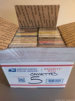 Open USPS box showing cassettes inside