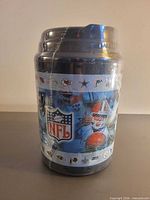 Front view of shrink-wrapped NFL mug showing logos and player imagery