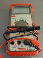 Front view of multimeter with attached leads
