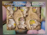 Front of retail box showing six porcelain tumbling bunny figurines