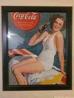 Full view of framed Coca-Cola poster featuring woman in swimsuit