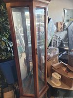 Front view of tall wooden-framed glass display cabinet