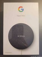 Front of sealed retail box displaying Google Nest Mini 2nd Generation in charcoal