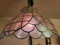 Side view of illuminated stained glass lamp showing overall shape and color