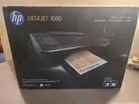 Front of sealed box with image and model name HP DeskJet 1050