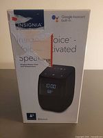 Front of sealed Insignia voice-activated speaker box