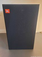 Front view showing JBL badge and cloth grille