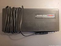 Overall view of Koss KCK/20T transmitter with coiled cable