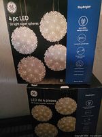 Front view of two GE StayBright LED super sphere boxes