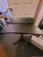Full view of black adjustable laptop desk