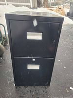 Front view showing two drawers with silver pulls and lock