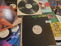 Spread of assorted vinyl records showing different sleeves and labels