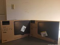 Front view of two sealed Insignia 19 LED TV boxes