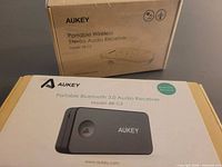 Front of Aukey BR-C2 box beside BR-C9 box