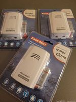 Front view of three sealed First Alert water alarms