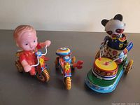 Group shot showing all three tin wind-up toys