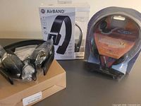 All three boxed headphone products on table