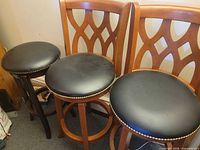 Three stools side by side showing backs and seats