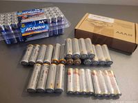 Group shot of all battery packs including ACDelco AA pack, Nanfu AAA box, and shrink-wrapped AAA batteries