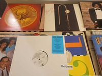 Top row of records showing Earth Wind & Fire emblem, brass instrument cover and Michael Jackson Off The Wall