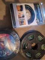 Group view of three rope light spools: Sunbeam 25 ft spool, sealed Super Bright Rope Light Kit, separate black reel