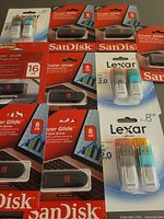 All packaged SanDisk and Lexar USB drives laid out