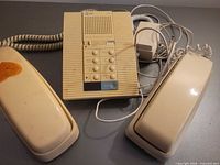 All three items: two beige handset phones and AT&T answering machine with cords