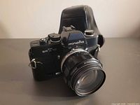 Front three-quarter view of Minolta SR-T 101 camera with lens and case