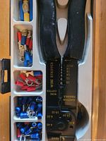 Wire stripper tool and terminals in tray close-up