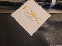 Close-up of DK Donna Karan tag attached to bag