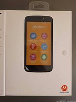 Front of sealed retail box displaying Motorola Moto e5 Go phone image and key feature icons