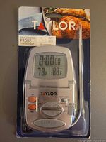 Front of sealed package showing Taylor digital probe thermometer and stainless steel probe