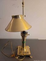 Full lamp showing base, column, shade and cord