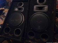 Front view of both speakers showing drivers and ports