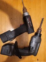 Overview of both cordless drills showing overall wear, battery packs, bits
