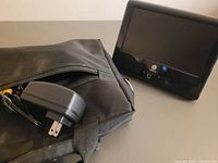 Television, power adapter and carrying case together