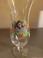 Full view of glass showing graphics and pedestal base