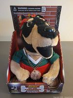 Front view of plush Doberman in retail display packaging
